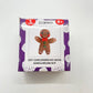 DIY gingerbread amigurumi knit or crochet kit in packaging in front of a white background.