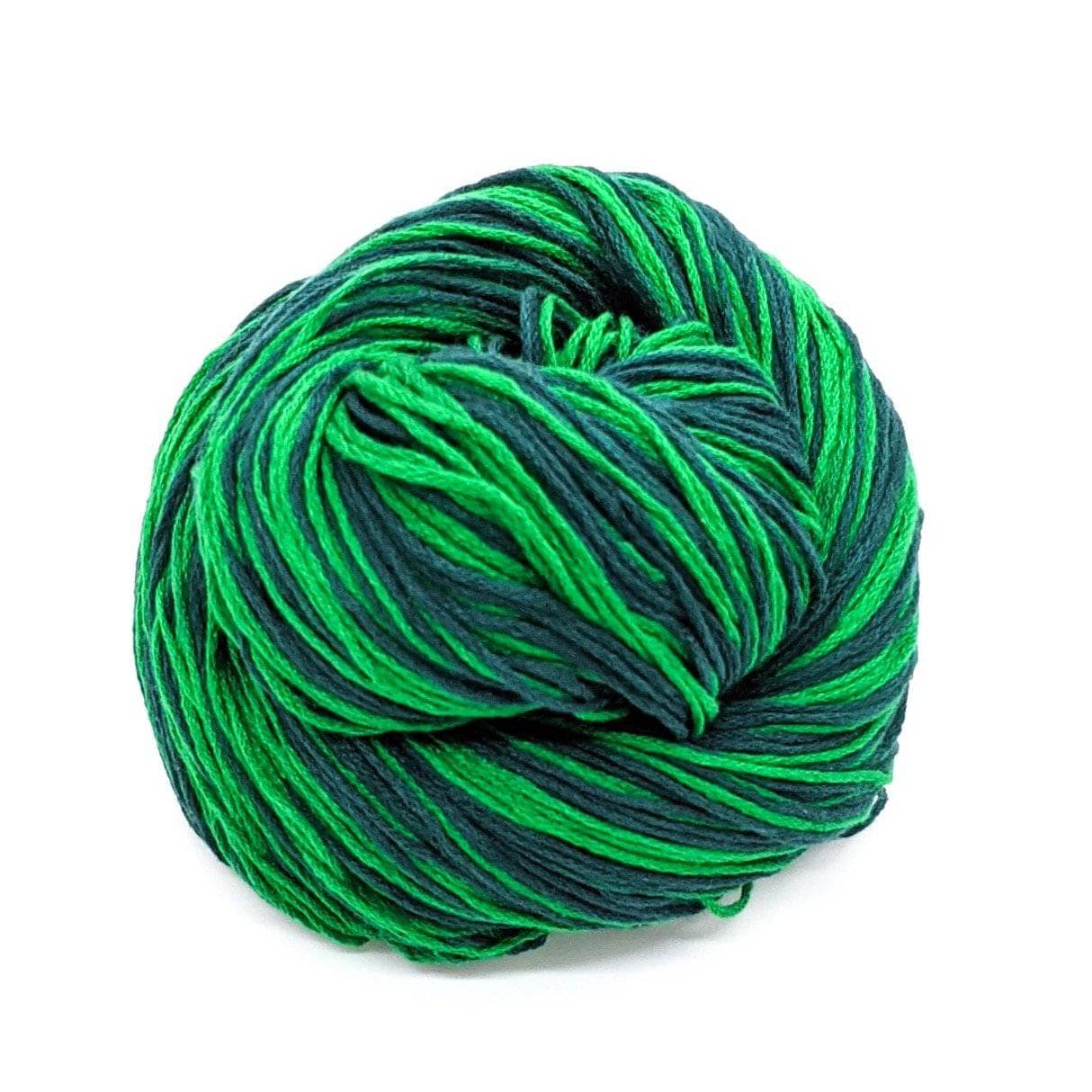 birds nested skein of mulberry silk fingering weight yarn in the colorway emerald lane (variegated emerald green and forest green) in front of a white background.