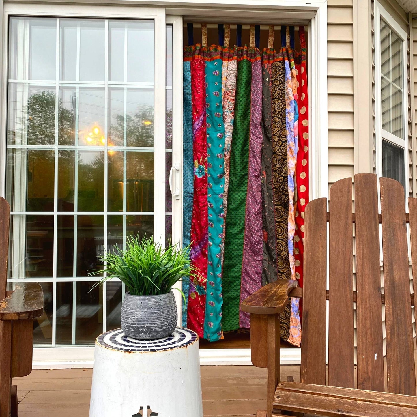 Outside view of patio drapes hanging in the doorway.