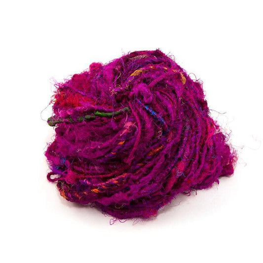  Recycled Silk Yarn close up in the color "Crimson Rose," a deep magenta, with a white background