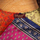 An up-close photo of a Sari Silk Purse, showing the detail of the stitching and the different patterns