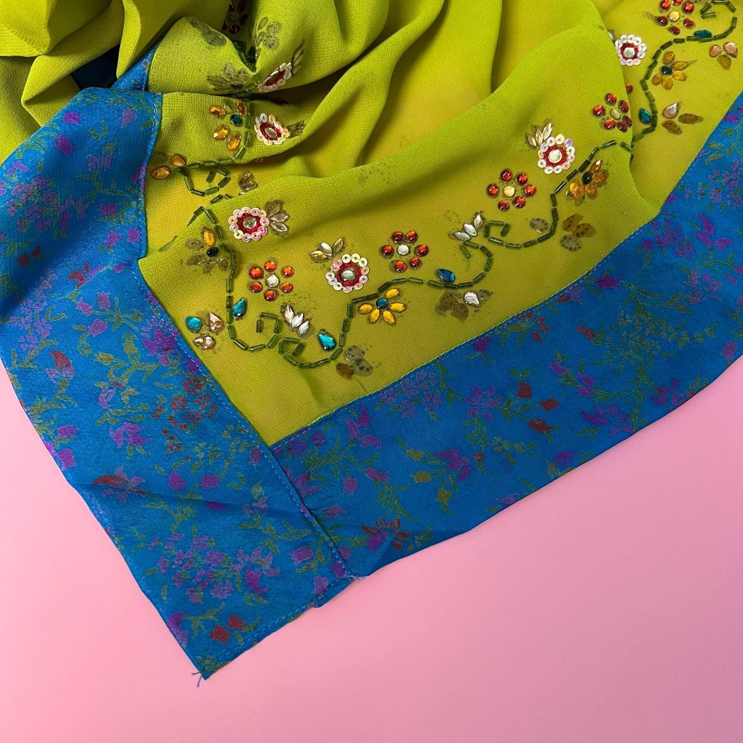 closeup of the heavy embellished edging on a green sophia duster.