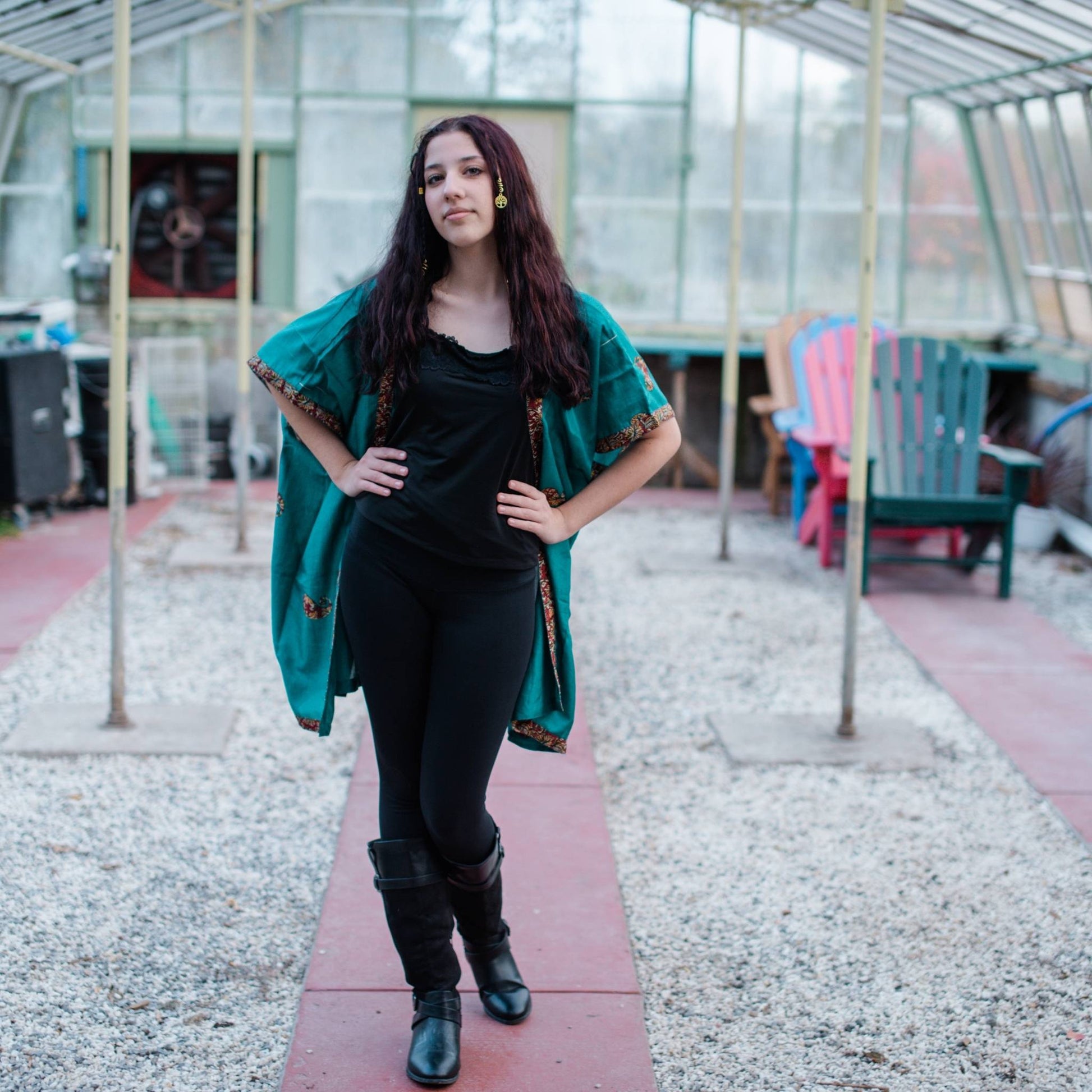 Model is in a greenhouse wearing a teal amara short duster. 