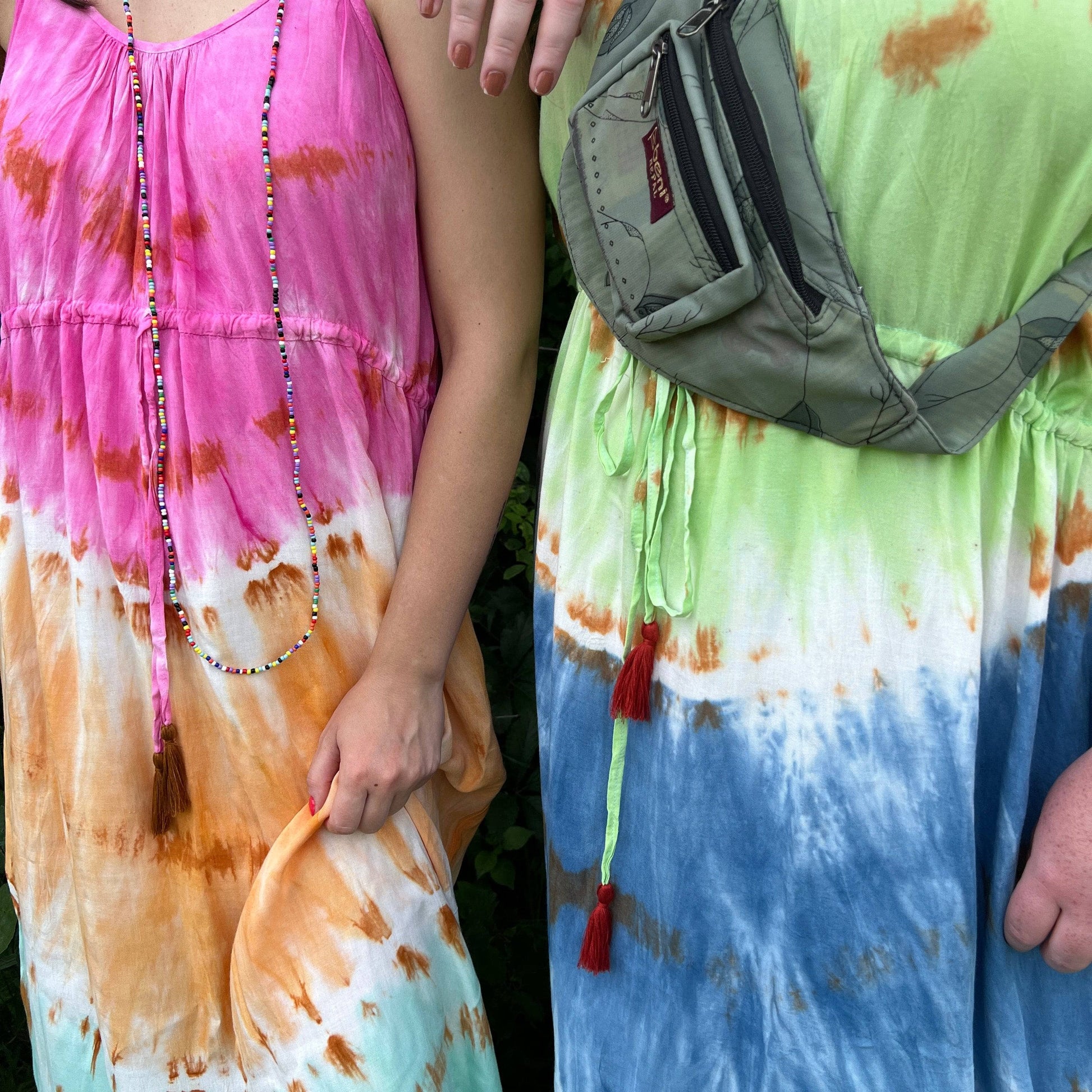 Close-up of both the blue breeze and rainbow sherbert tie dye maxi dresses.